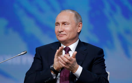 FILE PHOTO: Russian President Vladimir Putin applauds during a session of the International Arctic Forum in Saint Petersburg, Russia April 9, 2019. REUTERS/Anton Vaganov/File Photo