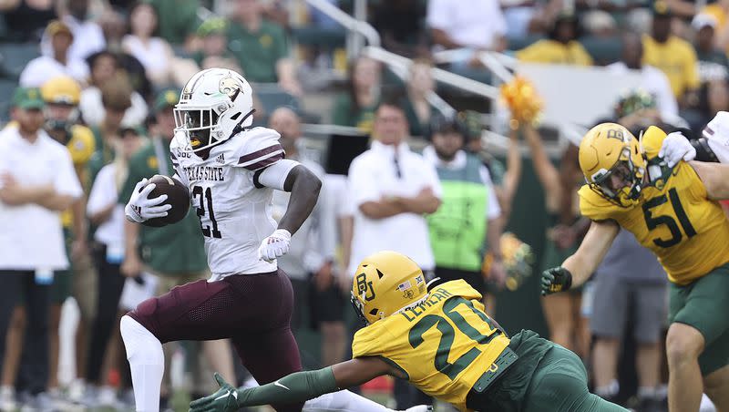 Texas State running back Ismail Mahdi (21) breaks the tackle of Baylor safety Devin Lemear (20) for a touchdown in the first half of an NCAA college football game, Saturday, Sept. 2, 2023, in Waco, Texas.