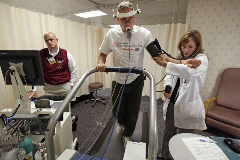 ** ADVANCE FOR MONDAY SEPT. 15 **Exercise physiologist Jesse Hickerson, left and R.N. Deborah Kuntz keep track of David Brookfield's vitals while performing a stress test at the McConnell Heart Health Center in Columbus, Ohio, Friday, June 20, 2008. He was taking advantage of the center's executive health and wellness program. (AP Photo/Columbus Dispatch, Chris Russell)