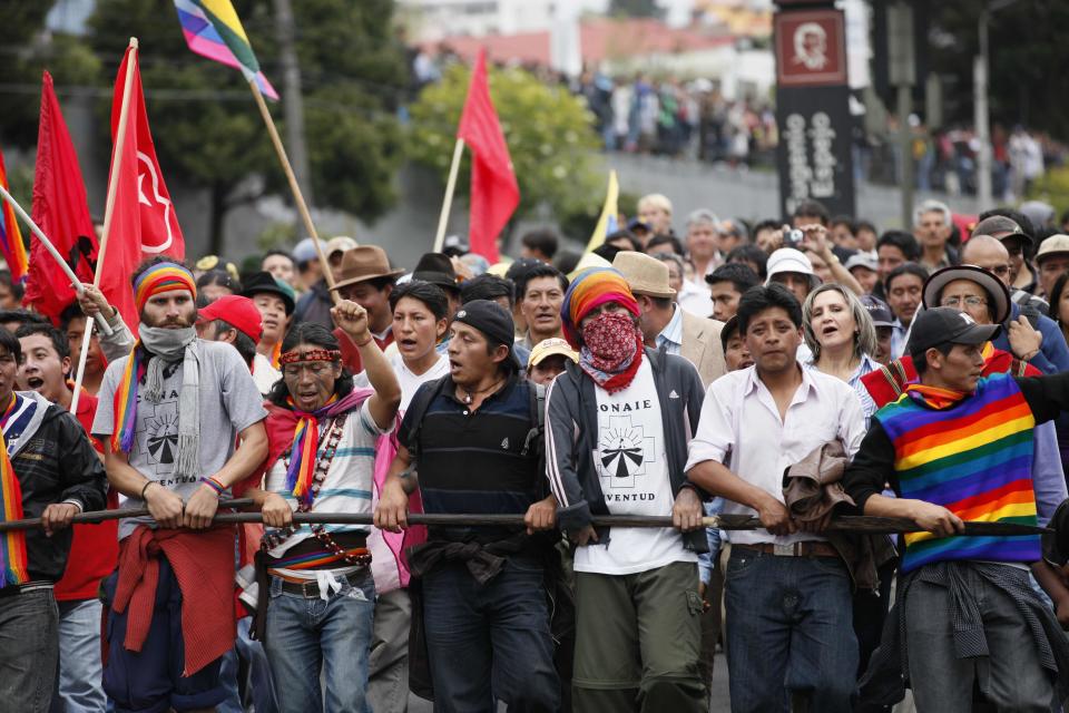 Indigenous an non-indigenous people protest the policies of President Rafael Correa as they march near the National Assembly in Quito, Ecuador, Thursday March 22, 2012. Protesters reached Ecuador's capital on Thursday after a two-week march from the Amazon to oppose plans for large-scaling mining projects on their lands. (AP Photo/Dolores Ochoa)