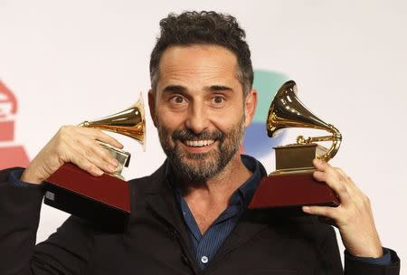 Uruguayan musician Jorge Drexler poses with his Record of the Year award for "Universos Paralelos" and Best Singer/Songwriter award for "Bailar En La Cueva" during the 15th Annual Latin Grammy Awards in Las Vegas, Nevada November 20, 2014. REUTERS/Steve Marcus