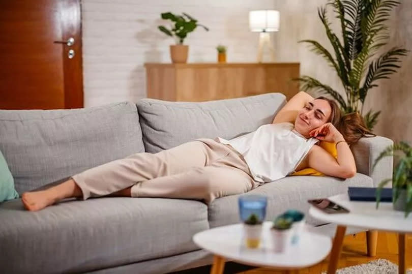 Young Woman Relaxing On The Sofa At Home