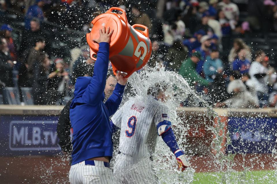Brandon Nimmo (9) is splashed with a Gatorade shower after hitting a walk-off two-run home run to defeat the Atlanta Braves, 4-3, at Citi Field.