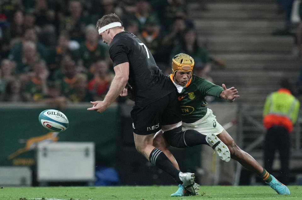 New Zealand's captain Sam Cane, left, is challenged by South Africa's Kurt-Lee Arendse during the Rugby Championship test between South Africa and New Zealand at Mbombela Stadium in Mbombela, South Africa, Saturday, Aug. 6, 2022. (AP Photo/Themba Hadebe)