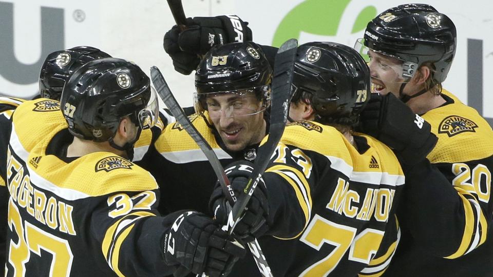 <p>Boston Bruins' Brad Marchand, center, celebrates after scoring the winning goal in overtime with teammates Patrice Bergeron (37), Charlie McAvoy (73) and Joakim Nordstrom (20) against the Avalanche, Sunday, Feb. 10, 2019. (AP Photo/Steven Senne)</p>