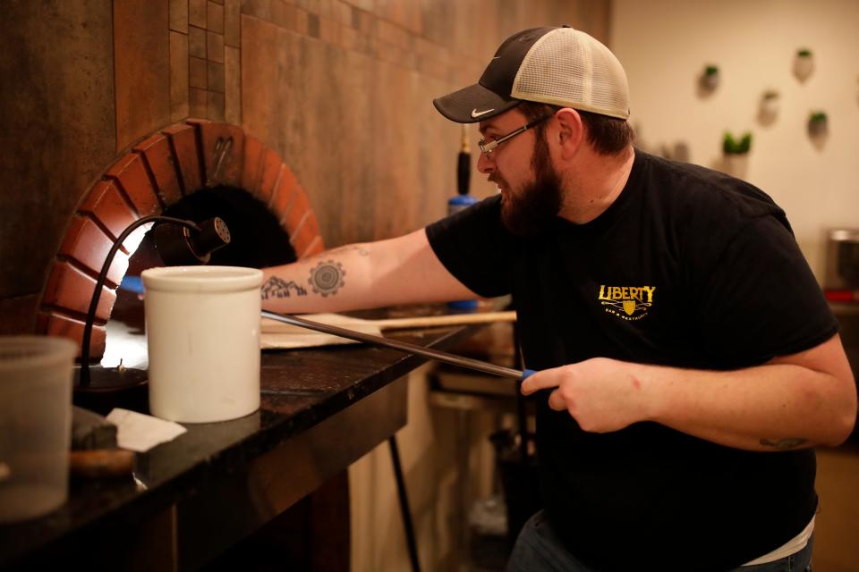 Hawthorn Bistro and Bakery Owner Jesse Edmunds bakes multi-seeded country loaf bread in a wood fired oven Wednesday, Jan. 30, 2019 at the re-invented restaurant that will have its grand opening Feb. 8, 2019. 