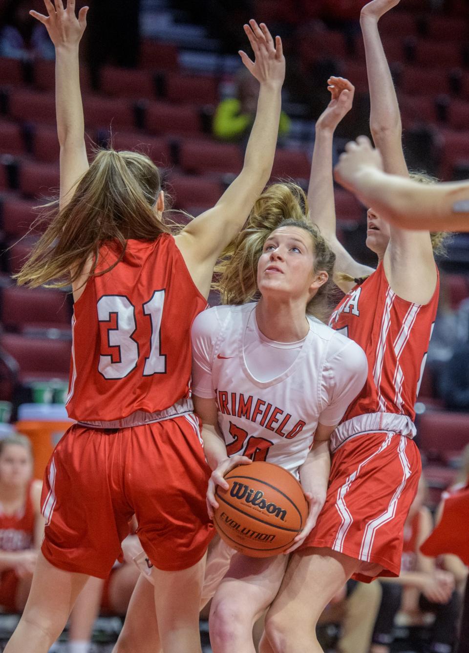 Brimfield's Ella Lune tries to split a pair of Neoga defenders under the basket in the first half of their Class 1A state semifinal Thursday, March 3, 2022 at Redbird Arena in Normal. Brimfield advanced to the Saturday title game with a 60-44 win.