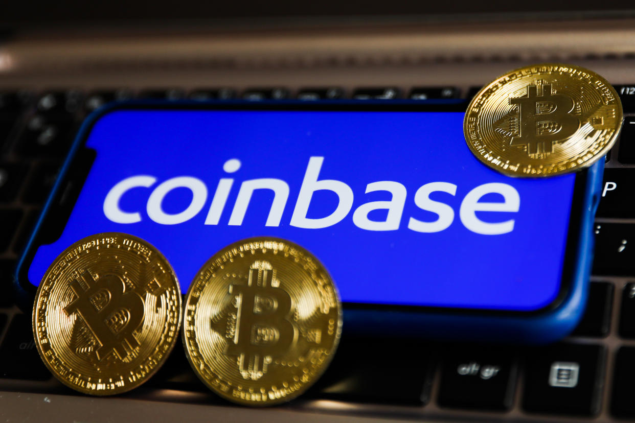 Coinbase logo displayed on a phone screen and representation of Bitcoin are seen in this illustration photo taken in Krakow, Poland on April 15, 2021 (Photo by Jakub Porzycki/NurPhoto via Getty Images)