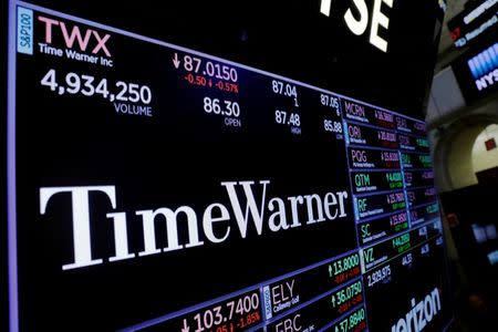 A screen shows the current price of Time Warner shares, above the floor of the New York Stock Exchange, shortly after the opening bell in New York, U.S., November 15, 2017. REUTERS/Lucas Jackson