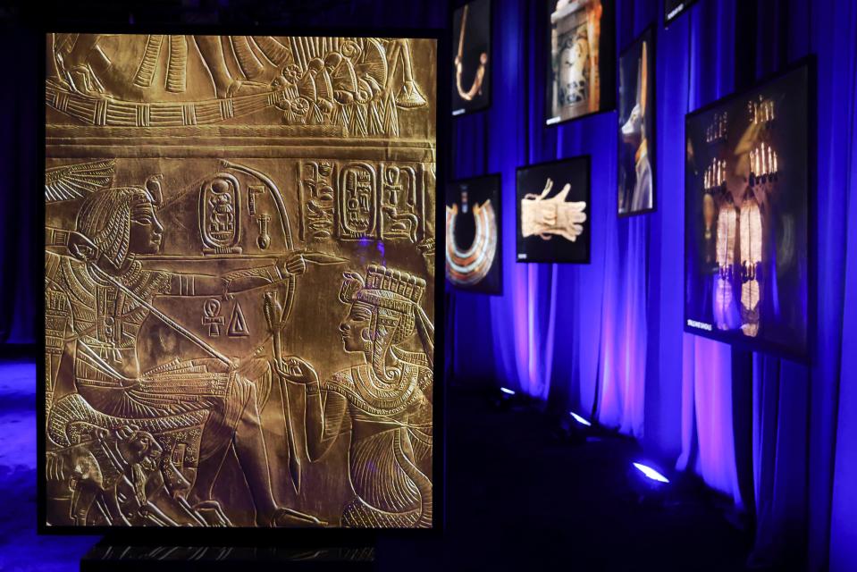 Photos of artifacts found in King Tut's tomb are displayed at the King Tut Immersive Experience, Thursday, Oct. 27, 2022, in New York. The exhibition will open to the public on Friday, in commemoration of the the 100th anniversary of the discovery of King Tut's tomb on Nov. 4, 1922. (AP Photo/Julia Nikhinson)