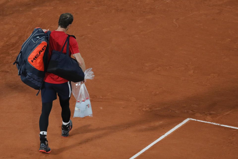 Britain's Andy Murray leaves after losing in three sets 1-6, 3-6, 2-6, against Switzerland's Stan Wawrinka in the first round match of the French Open tennis tournament at the Roland Garros stadium in Paris, France, Sunday, Sept. 27, 2020. (AP Photo/Christophe Ena)