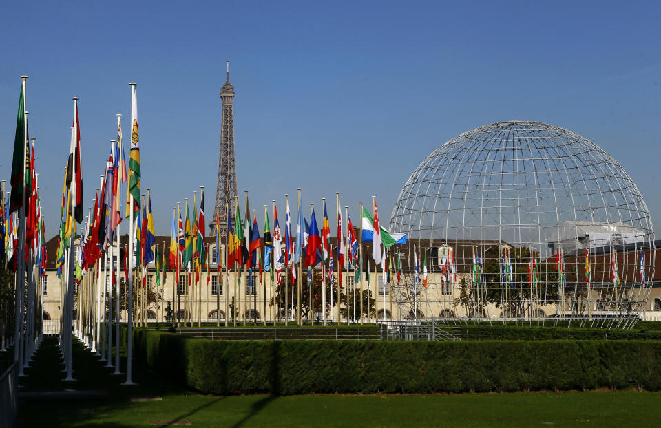 FILE - The Eiffel Tower, country flags and the Dome are seen from the garden of the United Nations Educational, Scientific and Cultural Organisation (UNESCO) headquarters building during the 39th session of the General Conference at the UNESCO headquarters in Paris. A White House official says President Joe Biden will nominate a top aide to both Vice President Kamala Harris and her husband, Doug Emhoff, to represent the United States at the United Nations agency devoted to education, science and culture. Courtney O'Donnell is Biden's choice to become the U.S. permanent representative, with the rank of ambassador, to the Paris-based UNESCO. (AP Photo/Francois Mori, File)