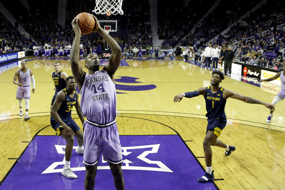 Kansas State's Makol Mawien (14) puts up a shot during the second half of an NCAA college basketball game against West Virginia Saturday, Jan. 18, 2020 in Lawrence, Kan. Kansas State won 84-68. (AP Photo/Charlie Riedel)