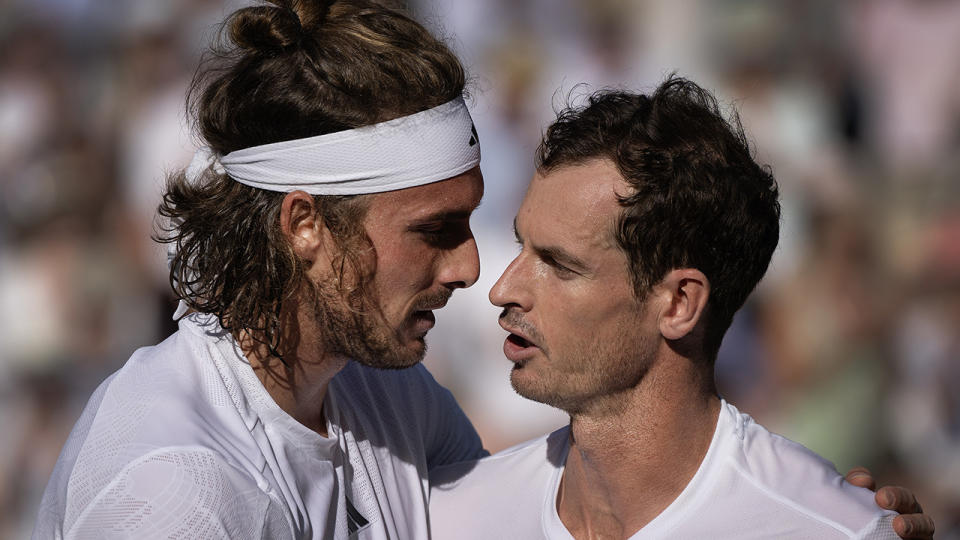 Stefanos Tsitsipas and Andy Murray converse at the net after their Wimbledon match.