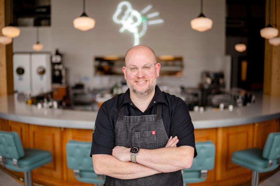 Chris Hoffmann, the chef and owner at Clyde's Fine Diner and a semifinalist for Best Chef Midwest from the James Beard Foundation, stands in front of a doodle that inspired the design of his restaurant in the East Village.