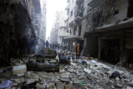 Residents look for survivors at a damaged site after what activists said was an air strike from forces loyal to Syria's President Bashar al-Assad in Takeek Al-Bab area of Aleppo