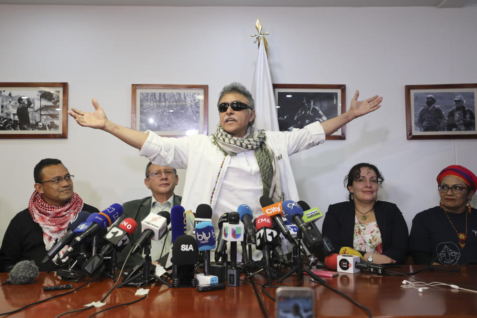 FILE - In this May 30, 2019 file photo, former rebel leader Seuxis Hernandez, also known as Jesus Santrich, opens his arms during a press conference at the FARC party headquarters after he was freed from his second detention in connection with a drug case in Bogota, Colombia. The rebel leader who abandoned a 2016 peace deal with Colombia’s government and had been at large for three years was killed in Venezuela on Monday, May 18, 2021, according to a statement published by his new armed movement. (AP Photo/Fernando Vergara, File)