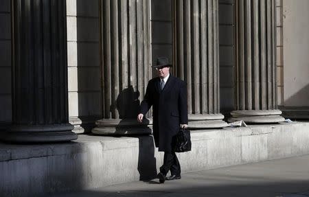 A man walks past the Bank of England in London March 5, 2015. REUTERS/Suzanne Plunkett