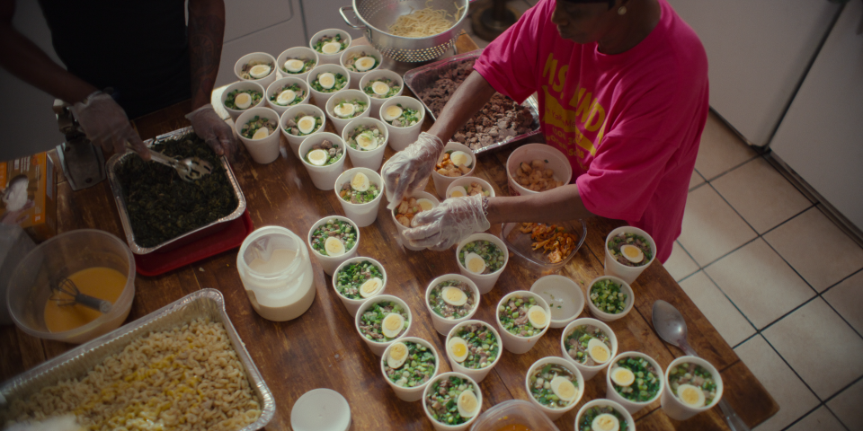 Linda Green prepares serving of her famous yakamein in the New Orleans episode of the Netflix series "Street Food: USA."