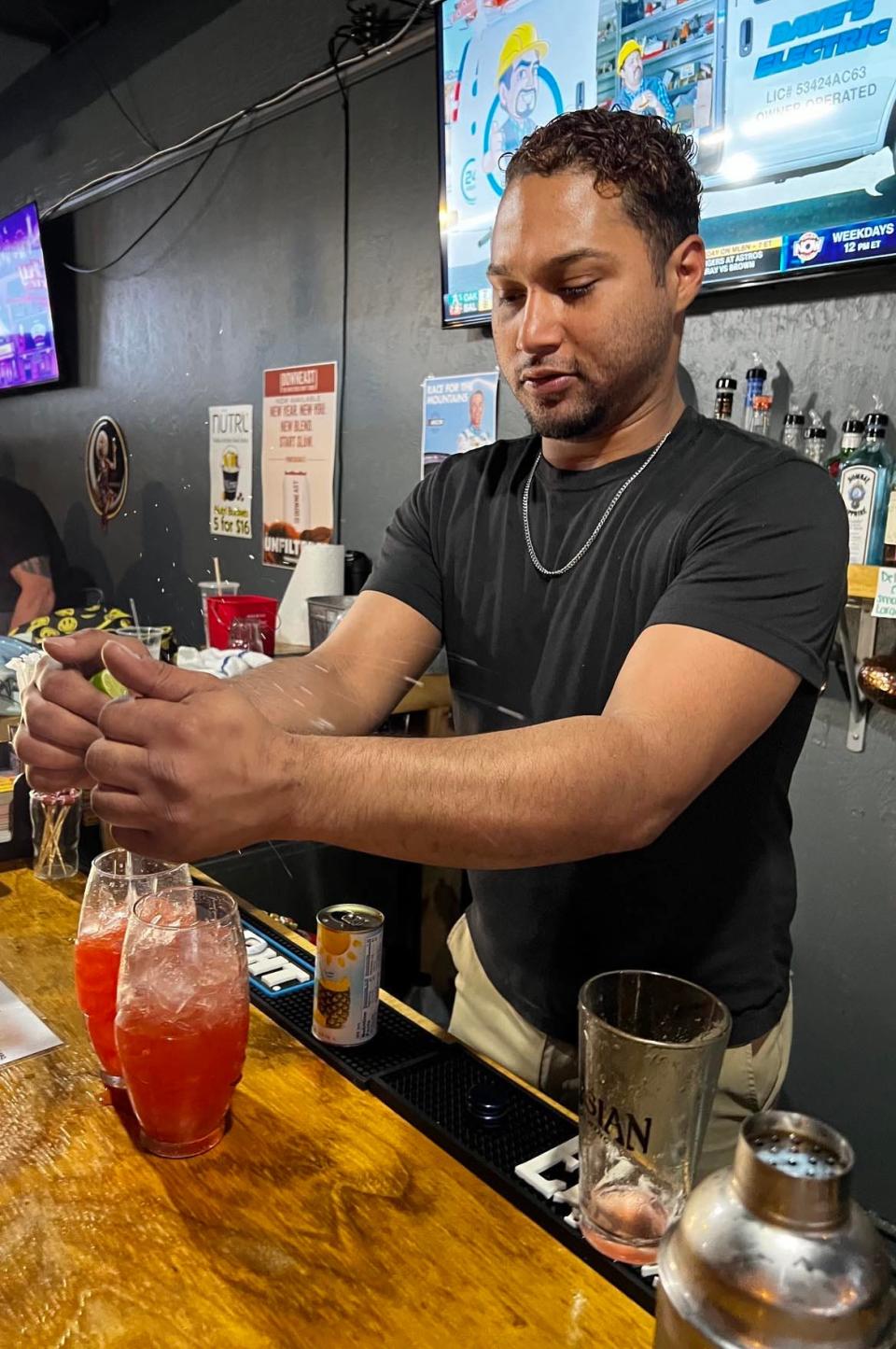 Jamal Gomez, of Gridiron Pizza & Sports Bar, serves a cocktail at the downtown Canton hangout. Gomez recently revamped the drink menu.