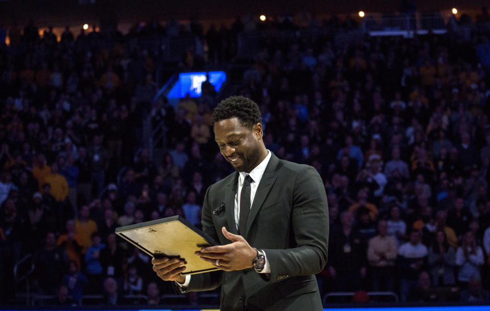 Miami Heat player and Marquette alumni Dwyane Wade is honored with Dwyane Wade Day during half time as Marquette takes on Providence for an NCAA college basketball game Sunday, Jan. 20, 2019, in Milwaukee. (AP Photo/Darren Hauck)