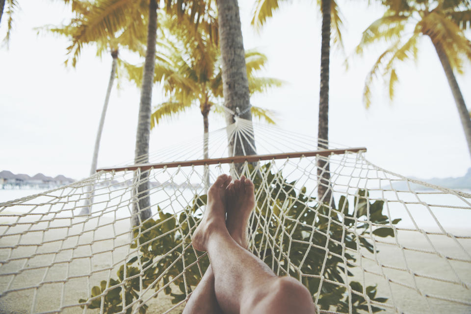 Relaxing feet on a beach hammock.