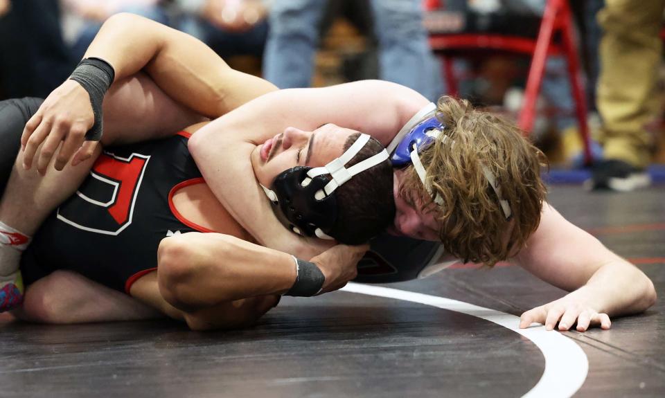 North Quincy's Matthew Nellany, right, versus Durfee's Kayden Chaney during the division one south sectional wrestling championships at Brockton High School on Saturday, Feb. 11, 2023.