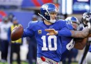 Dec 15, 2013; East Rutherford, NJ, USA; New York Giants quarterback Eli Manning (10) throws a pass during the first half against the Seattle Seahawks at MetLife Stadium. Mandatory Credit: Jim O'Connor-USA TODAY Sports