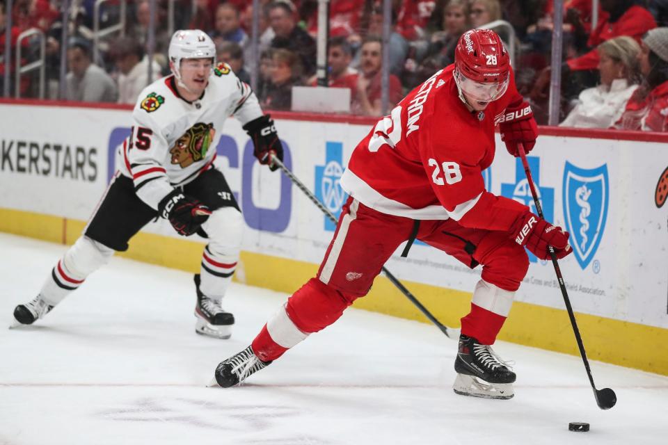 Red Wings defenseman Gustav Lindstrom looks to pass against Blackhawks right wing Joey Anderson during the second period on Wednesday, March 8, 2023, at Little Caesars Arena.