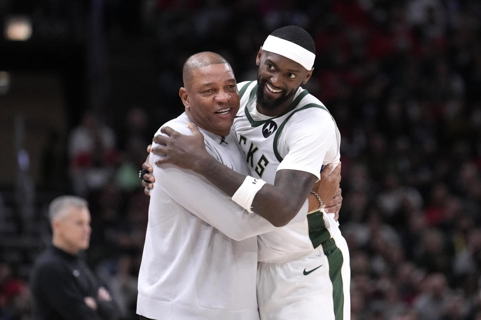 Milwaukee Bucks coach Doc Rivers hugs Bobby Portis during the second half of the team's NBA basketball game against the Chicago Bulls on Friday, March 1, 2024, in Chicago. (AP Photo/Charles Rex Arbogast)