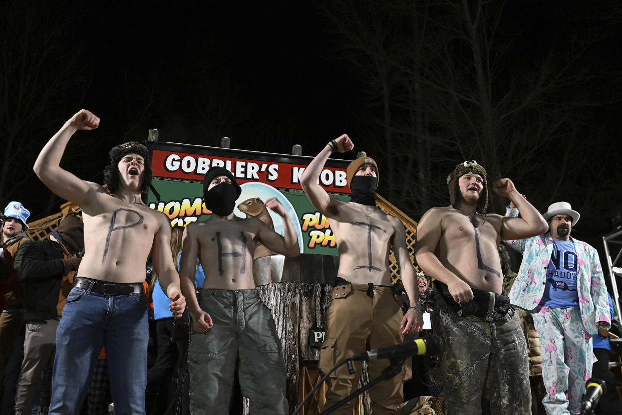 A group of spectators entertain the crowd while waiting for Punxsutawney Phil, the weather prognosticating groundhog, to come out and make his prediction during the 137th celebration of Groundhog Day on Gobbler's Knob in Punxsutawney, Pa., Thursday, Feb. 2, 2023. (AP Photo/Barry Reeger)