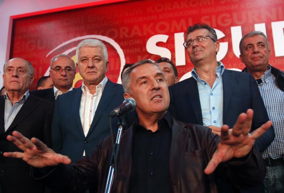 In this Monday, Oct. 17, 2016 file photo, former Montenegro's Prime Minister and long-ruling Democratic Party of Socialists leader Milo Djukanovic, center, speaks in his headquarter, in Podgorica, Montenegro. Montenegro's special prosecutor Milivoje Katnic, has accused Russia and its secret service operatives of plotting a coup attempt that included plans to kill the small Balkan country's former prime minister, Milo Djukanovic, following an investigation. (AP Photo/Darko Vojinovic, File)