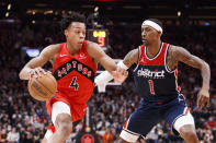 Toronto Raptors forward Scottie Barnes (4) drives to the net against Washington Wizards guard Kentavious Caldwell-Pope (1) during first-half NBA basketball game action in Toronto, Sunday, Dec. 5, 2021. (Cole Burston/The Canadian Press via AP)