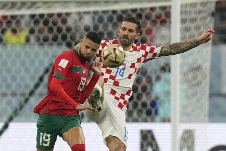 Morocco's Youssef En-Nesyri, left, and Croatia's Marko Livaja fight for the ball during the World Cup third-place playoff soccer match between Croatia and Morocco at Khalifa International Stadium in Doha, Qatar, Friday, Dec. 16, 2022. (AP Photo/Thanassis Stavrakis)