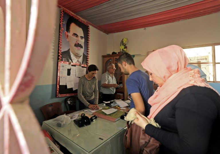 Syrians register for the first local elections in the northeastern city of Qamishli on September 19, 2017