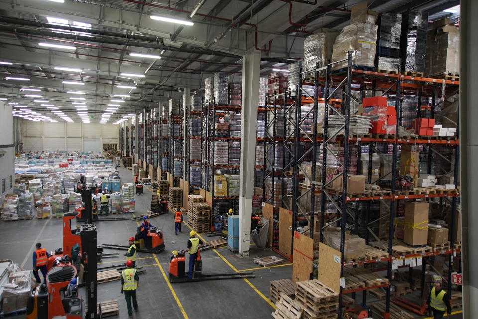 Supermarket warehouse workers ride trolleys and sort food and drinks near Teresin, Poland, March 12, 2019, with nearly half the workers being Ukrainian. Millions of Ukrainians, an estimated one in 10, have left their country to seek the opportunity of working abroad, as many see no hope if they remain at home. (AP Photo/Mstyslav Chernov)