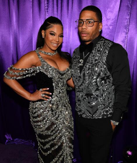 Ashanti smiles in a glitter gown with rappy Nelly