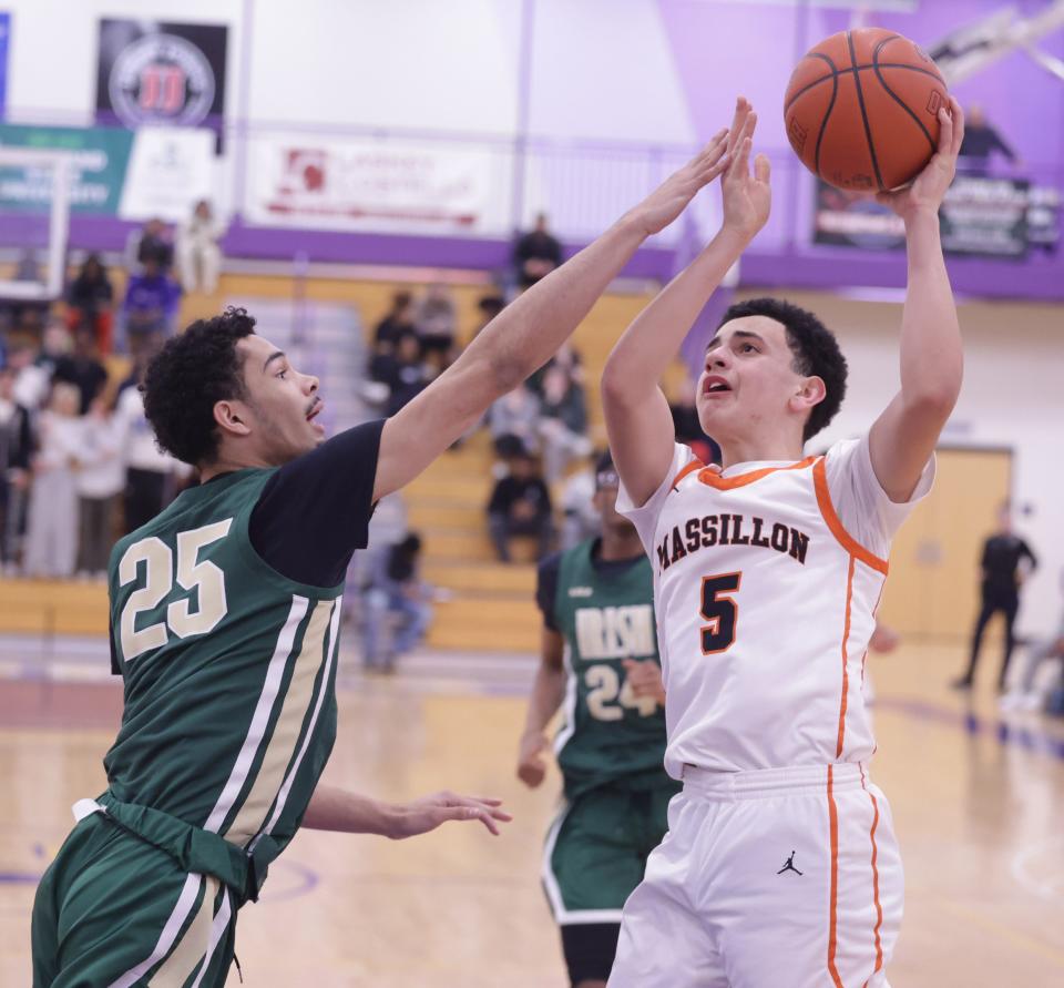 Massillon's Braylon Gamble looks to shoot in the second half with pressure from St. Vincent-St. Mary's Shannon Payne in an OHSAA district semifinal, Thursday, March 7, 2024.