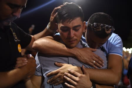 People gather for a vigil a day after a mass shooting in El Paso