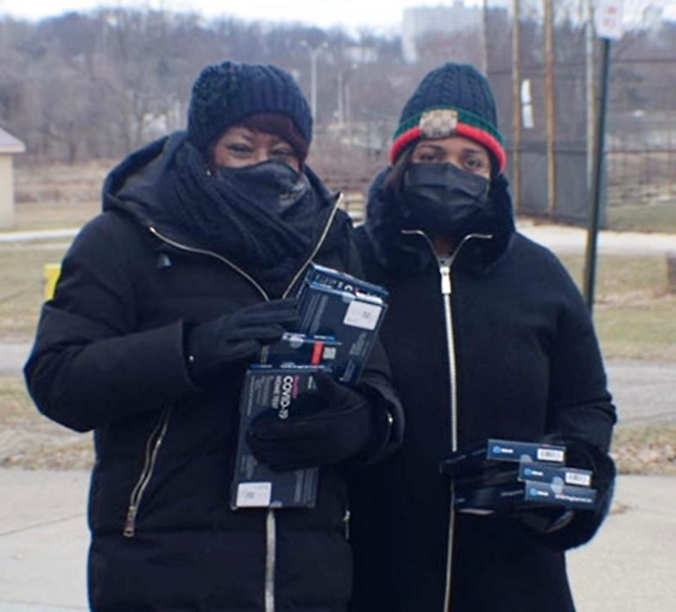 Joan Williams, left, chief of staff for Akron City Council, and Margo Sommerville, council president, were among council members who distributed free at-home coronavirus tests Saturday.