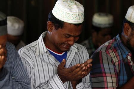 A muslim man cries after a group of men destroyed a mosque in the first serious outburst of inter-religious violence in months in the village of Thayethamin outside Yangon, Myanmar June 24, 2016. REUTERS/Soe Zeya Tun