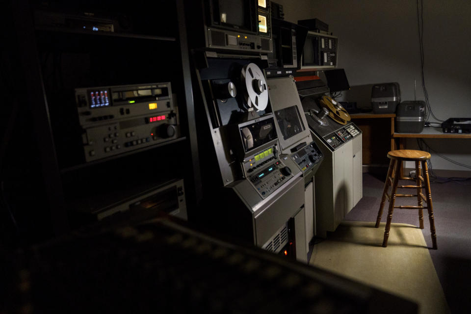 Professional editing equipment stands next to an empty stool in the studio where audio and video guru Larry Quackenbush worked as a producer for Assemblies of God, a Pentecostal denomination based in Springfield, Mo., Tuesday, March 22, 2022. Quackenbush died from COVID-19 on Aug. 3, 2021 after contracting the virus while caring for his son, Landon, who had tested positive along with Landon's mother. So it was no surprise that Larry jumped in to care for his son, not worried about his own fragile health. "Even when he started feeling sick, he kept taking care of everybody," daughter Macy Sweeters says. "It just hurts so much. He was my best friend." (AP Photo/David Goldman)