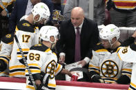 Boston Bruins head coach Jim Montgomery talks with his players during the third period of Game 3 of an NHL hockey Stanley Cup first-round playoff series against the Florida Panthers, Friday, April 21, 2023, in Sunrise, Fla. (AP Photo/Lynne Sladky)