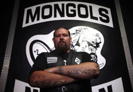 A member of the Mongols Motorcycle Club, known only as 'Ozzie', poses for a photograph in their clubhouse located in western Sydney November 9, 2014. REUTERS/David Gray
