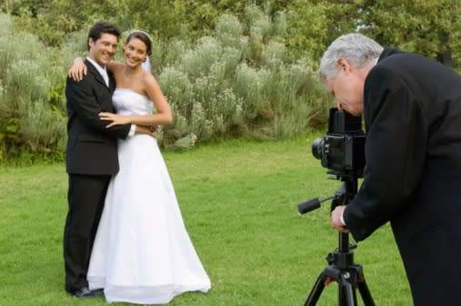 Newlywed couple posing for wedding photographer