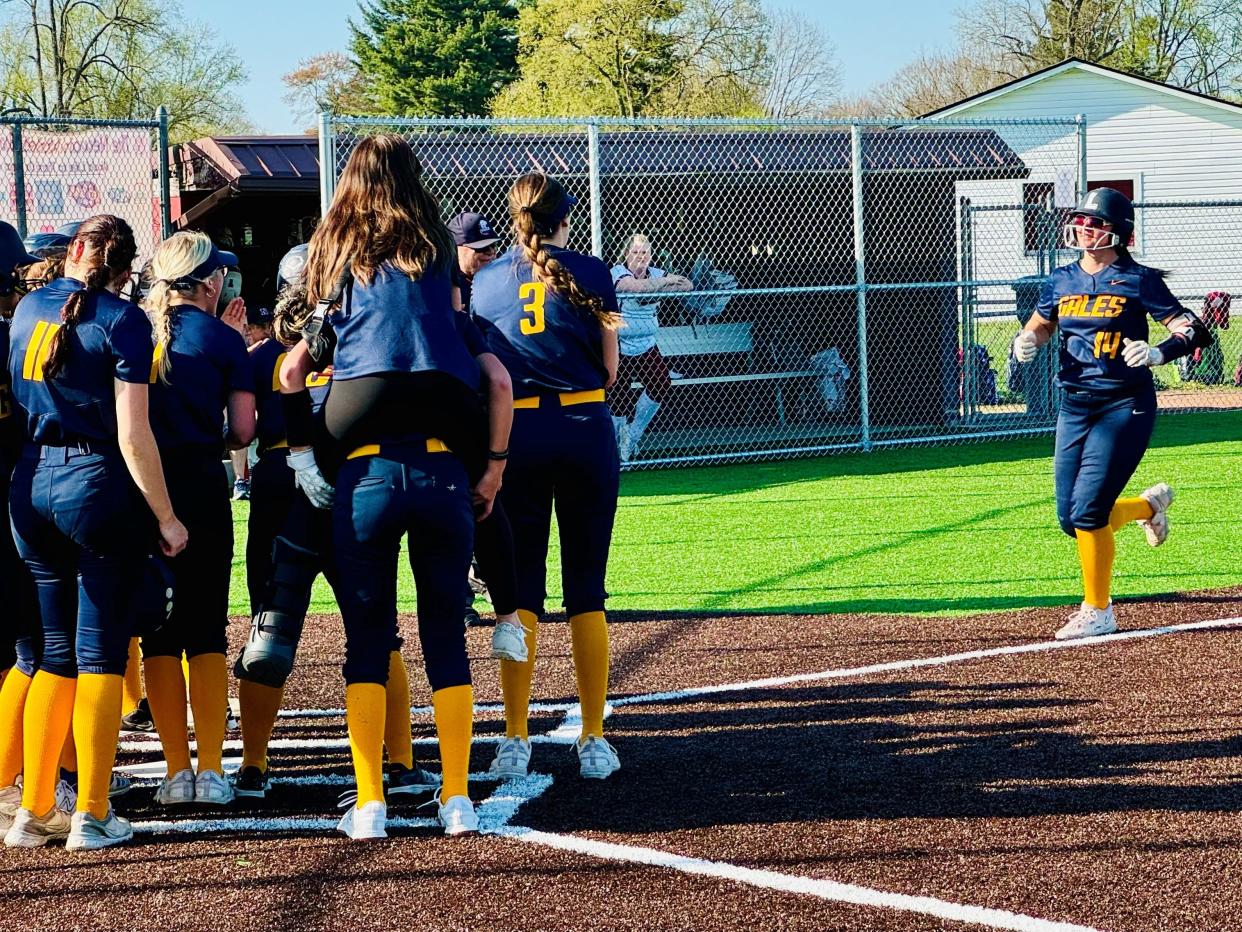 Ashlin Mowery's teammates wait for her at home plate after she hit a three-run home run in a 20-0 win over Newark. The Lady Gales are ranked No. 1 in the state in the Division I Ohio High School Fastpitch Softball Coaches Association.