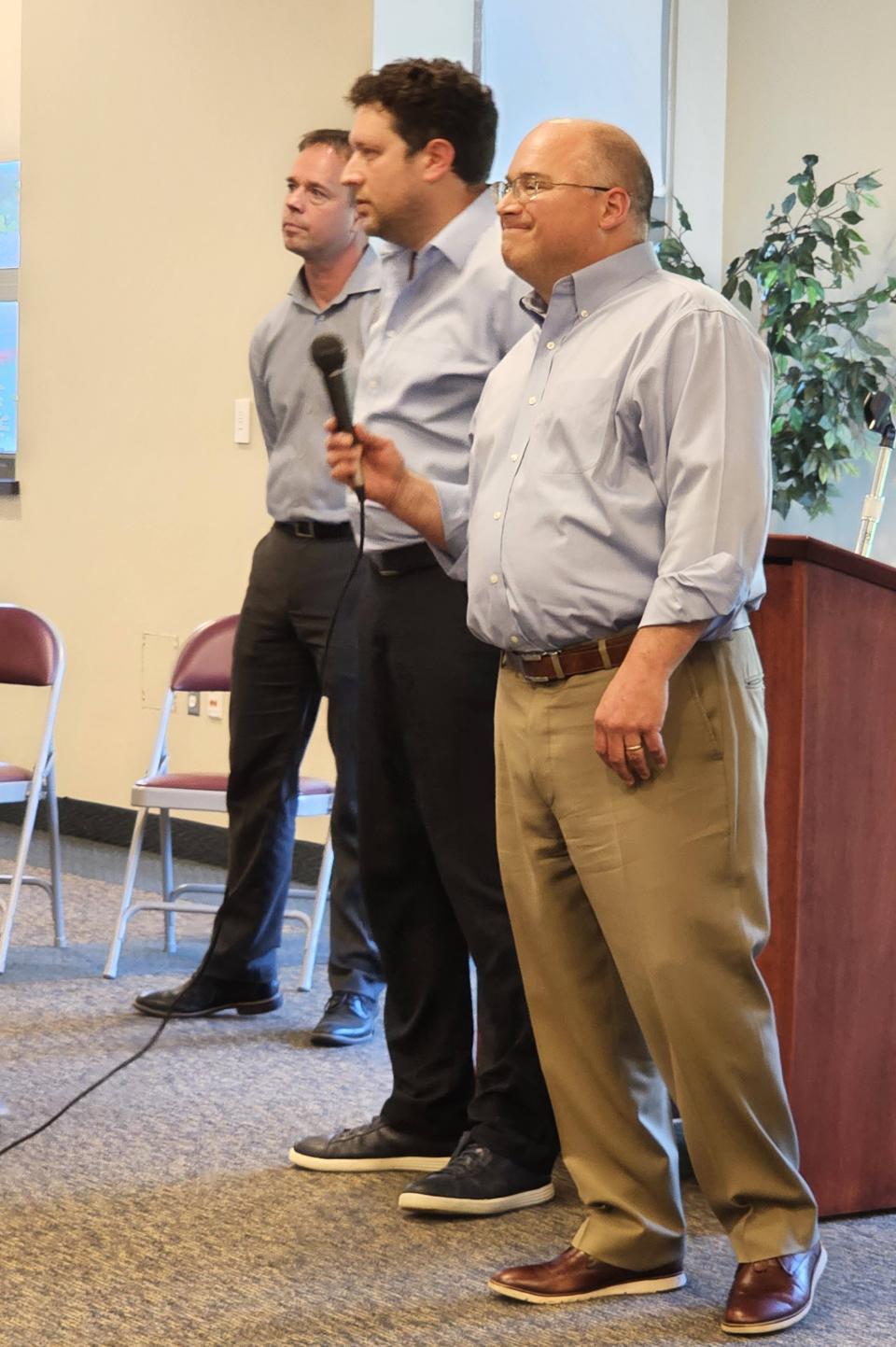 Culmen International founder and CEO Daniel Berkon, foreground, Granite Ridge's Jonathan Ehrenfeld, middle, and William Unger, left, listen to a North East resident Thursday, May 11, 2023. Ehrenfeld, the owner of the 70-acre Granite Ridge, has been in discussions with Culmen International, on partnering to bring an influx care facility to the former Mercyhurst North East campus. Culmen International is eligible to bid on a federal contract to provide housing and other services to unaccompanied migrant children for the U.S. Department of Health and Human Services. 