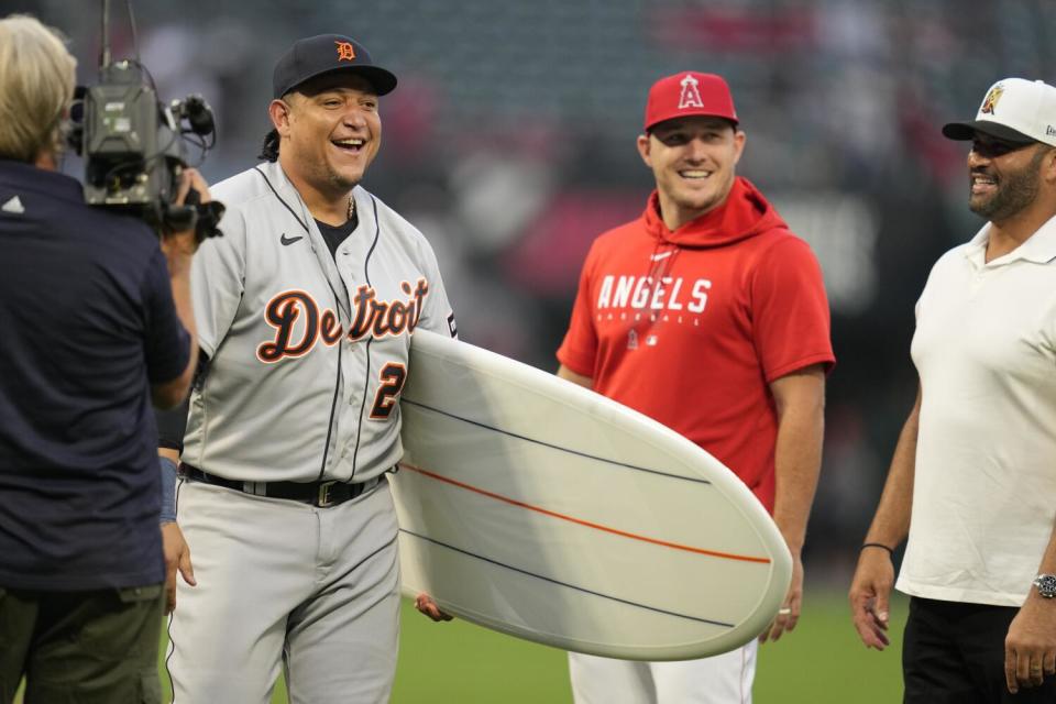 Detroit's Miguel Cabrera, left, smiles with Angels' Mike Trout, middle, and former MLB star Albert Pujols