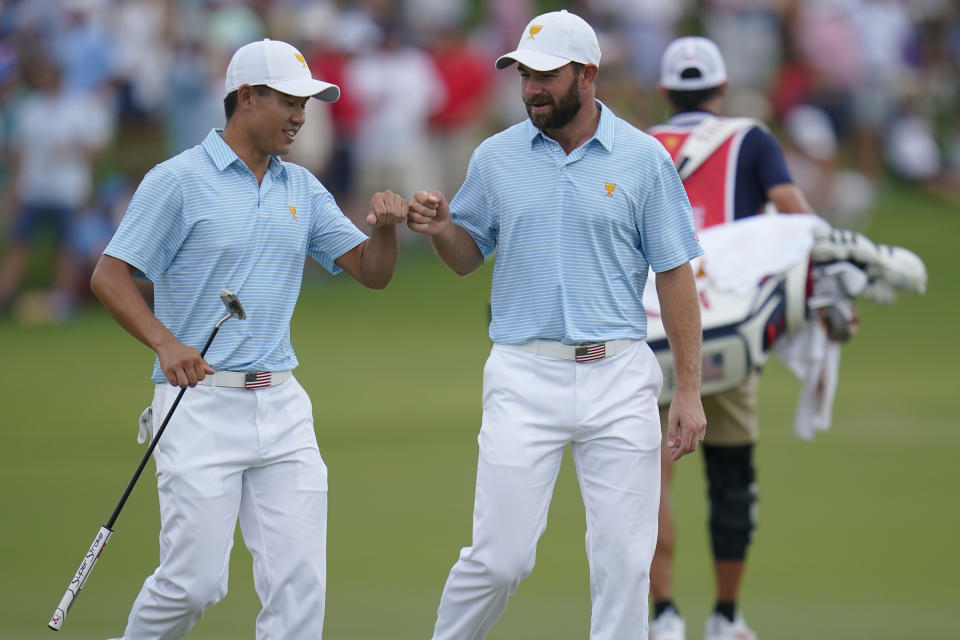 Collin Morikawa, left, and Cameron Young celebrate on the 15th green during their foursomes match at the Presidents Cup golf tournament at the Quail Hollow Club, Thursday, Sept. 22, 2022, in Charlotte, N.C. (AP Photo/Julio Cortez)