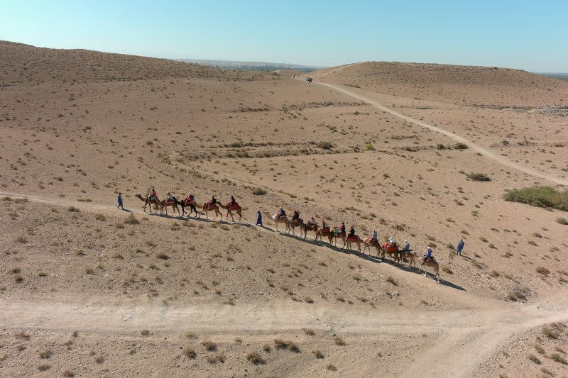 FILE PHOTO: An aerial view of tourists riding camels in the Agafay desert near Marrakech